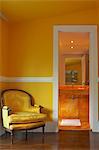 Brazil, Rio de Janeiro city, Gavea, La Suite Hotel, yellow marble bathroom and yellow bedroom showing faux yellow Louis XIV chair