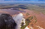 South America, Brazil, Parana, aerial view of the Devils Throat at the Iguazu falls when in full flood on the frontier of Brazil and Argentina.