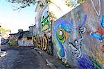 South America, Brazil, Sao Paulo, Vila Madalena, the Beco do Batman   an alley covered in Brazilian graffiti under the yellow neon glow of the Sao Paulo sky