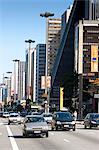 South America, Brazil, Sao Paulo, traffic and pedestrians on Avenida Paulista with the SESI and FIESP builiding in the foreground