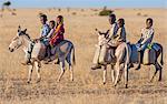 Chad, Biltine, Oum-Chelouba, Sahel. Children return home on donkeys after collecting water from a deep well.