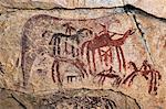 Chad, Guili Dweli, Ennedi, Sahara. Paintings of at least two distinct periods decorate the sandstone wall of a cave.