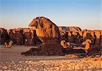 Chad, Abaike, Ennedi, Sahara. A large cluster of weathered sandstone columns in a desert landscape.