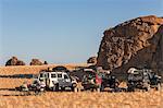 Chad, Abaike, Ennedi, Sahara. Visitors to Abaike having breakfast after packing up camp.