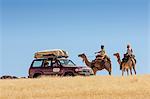 Chad, Bechike, Ennedi, Sahara. Toubou nomads explain a cross-country route to tourists.