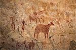 Chad, Deli, Ennedi, Sahara. A bichrome rock art panel on sandstone of human figures, cattle and two ostriches.