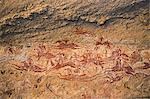 Chad, Terkei East, Ennedi, Sahara. A fine rock art panel on sandstone of galloping horses and their riders