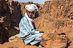 Chad, Wadi Archei, Ennedi, Sahara. A young Toubou boy on a ledge overlooking Wadi Archei.