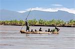 A large dugout canoe ferries Dassanech people across the Omo River, Ethiopia