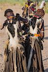Dassanech women dress in Dimi regalia   pleated leather skirts and a colobus monkey skin on their backs, Ethiopia