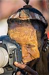 A Dassanech man photographs his friends at a Dimi ceremony, Ethiopia