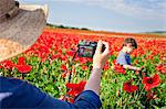 Italy, Tuscany, Siena district, Orcia Valley. Family in a poppies field