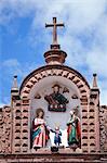 South America, Peru, Cusco. A representation of the holy family   Mary, Joseph and the Christ child with God the father on the roof of the church of Jesus and Mary on the plaza de armas in the UNESCO World Heritage listed former Inca capital of Cusco