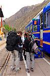 South America, Peru, Cusco, Sacred Valley, Ollantaytambo. Backpackers en route to Machu Picchu board the Vistadome train at Ollantaytambo. The train runs between Cusco, Poroy, and Machu Picchu via Ollantaytambo