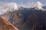 South America, Peru, Cusco. Hikers on an Inca road on the trail between Choquequirao and Cachora with the Apurimac valley and snow capped peaks behind