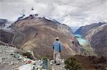 South America, Peru, Ancash, Cordillera Blanca. A hiker looking out over the Llanganuco lakes on the Santa Cruz trek in Huascaran National Park