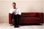 Mature Man Sitting on Sofa and Waiting