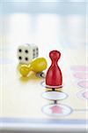 close-up of ludo board game with colored playing pieces and dice