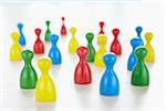 close-up of multi-colored playing pieces on white background