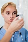 Focus on a nurse checking an intravenous drip