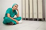 Nurse sitting cross-legged on the floor