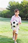 Boy playing with a football