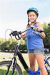 Portrait of smiling girl with her bike