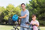 Happy father and son with their bikes