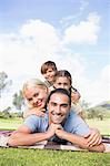 Portrait of posing family on picnic blanket