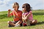 Little boy and girl blowing bubbles