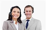 Smiling call center agents standing together against a white background
