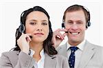 Call center team with their headsets against a white background
