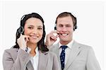 Smiling call center team with their headsets against a white background
