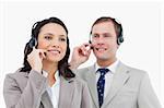 Telephone help desk employees with headsets against a white background