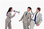 Businesswoman with megaphone yelling at colleagues against a white background