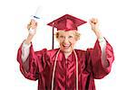 Senior woman dressed in her graduation cap and gown, raises her arms in excitement over getting her college degree.  Isolated on white.