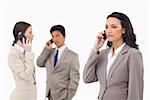 Businesspeople talking on the phone against a white background