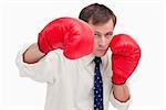 Striking businessman with boxing gloves against a white background