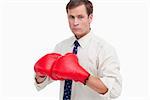 Businessman with boxing gloves ready to fight against a white background