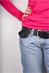 woman pink shirt detail with smartphone in her pocket jeans