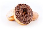 Doughnuts piled up together against a white background