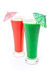 Two full glasses with cocktail umbrella against white background