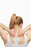 Blonde woman massaging her painful neck against white background
