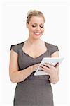 Woman using a tablet pc against white background