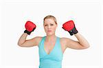 Woman rising her gloves against white background