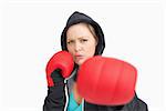 Woman with gloves hitting against white background