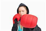 Woman fuzzy showing a boxing glove against white background