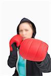 Woman boxing with a red gloves against white background