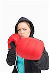 Concentrated woman boxing against white background