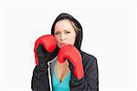 Serious woman boxing against white background
